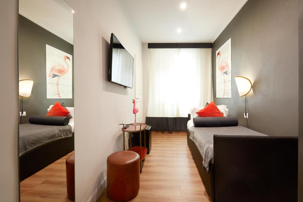 Postel nebo postele na pokoji v ubytování Boutique Hotel Hugo
