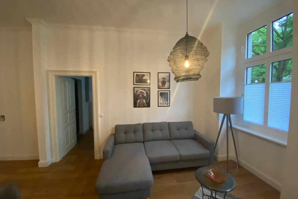 a living room with a couch and a window at MyHappyplace in the middle of Berlin in Berlin