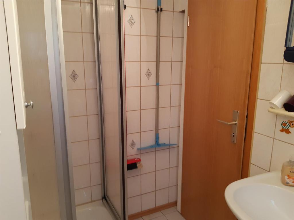 a shower with a glass door in a bathroom at Haus Bösenberg in Altenau