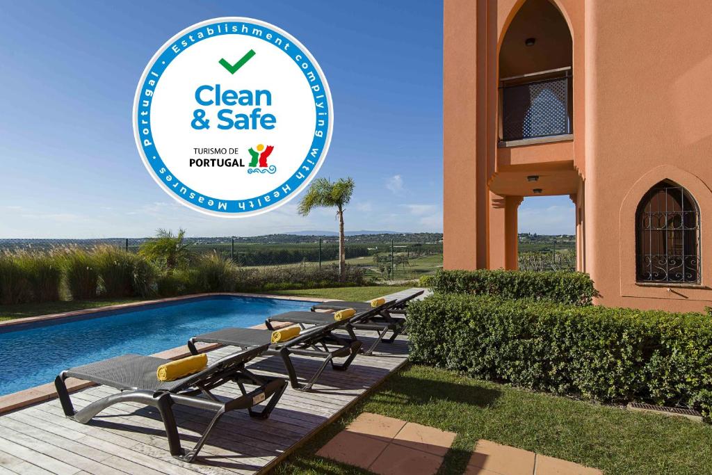 a hotel with a sign that reads clean and safe at Amendoeira Golf Resort in Armação de Pêra