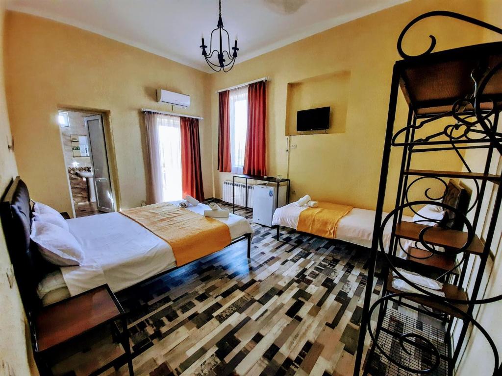 a bedroom with two beds and a bunk bed at Green Flower Hotel in Kutaisi