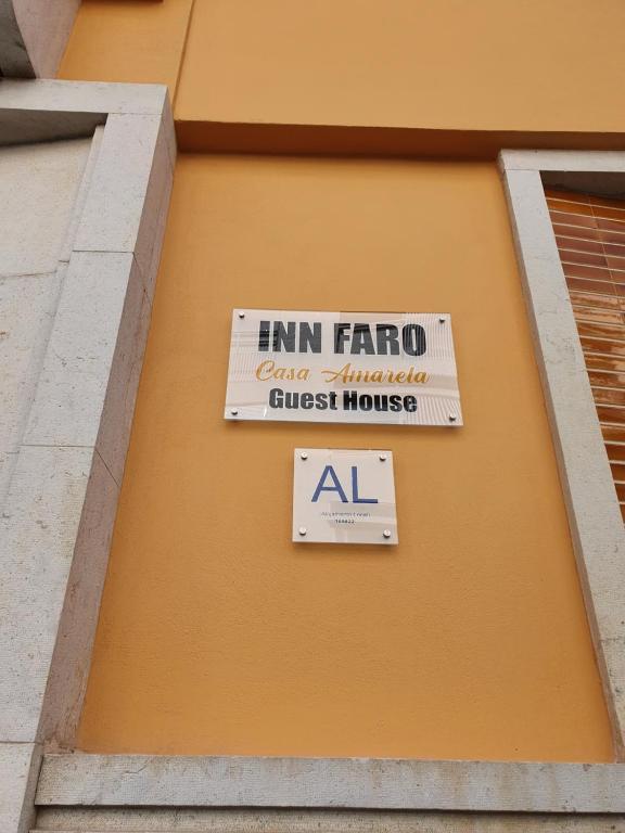 uma placa de casa de hóspedes emirato no lado de um edifício em Inn Faro - Casa Amarela - Guest House em Faro