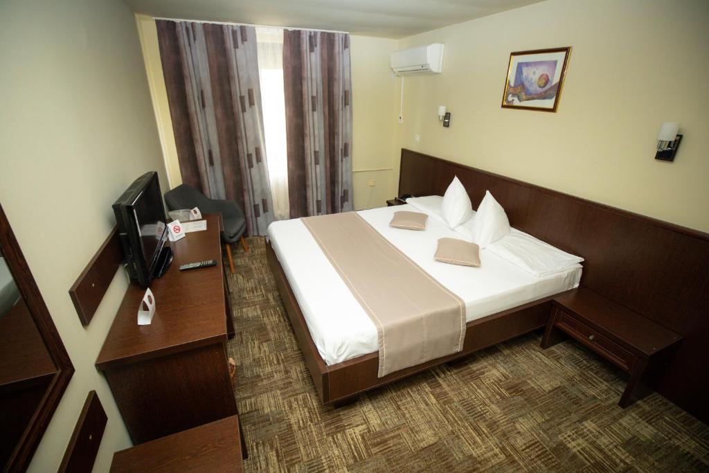 Postel nebo postele na pokoji v ubytování Hotel Select Slobozia