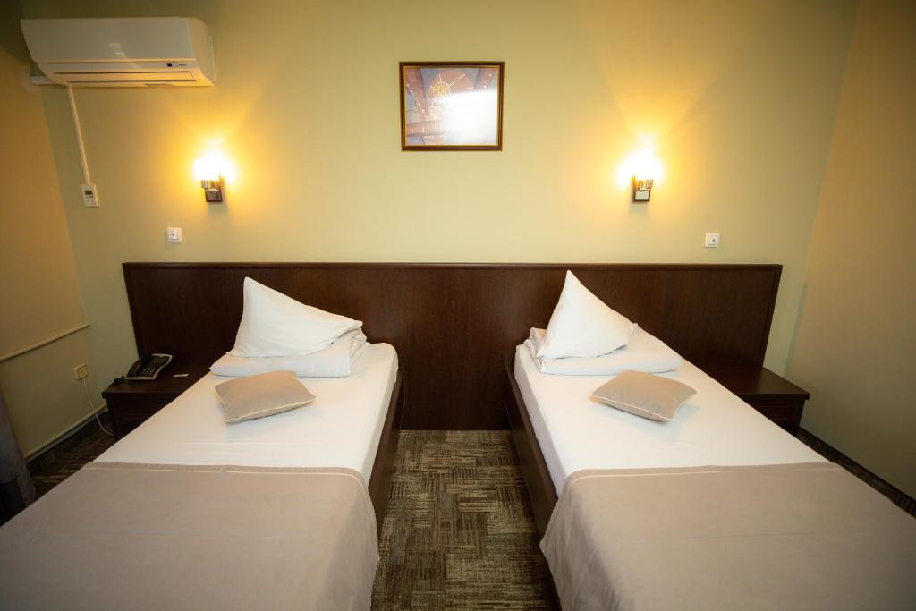 Postel nebo postele na pokoji v ubytování Hotel Select Slobozia