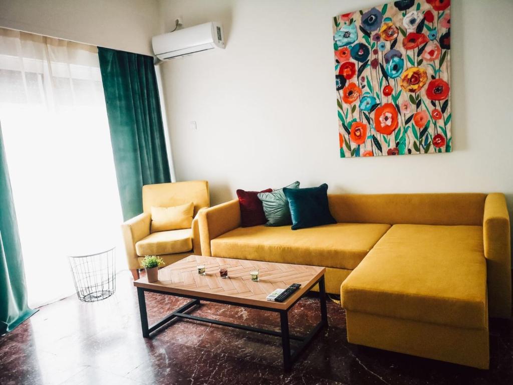 a living room with a couch and a coffee table at Explore Greece from Colorful City Centre Apartment in Chalkida
