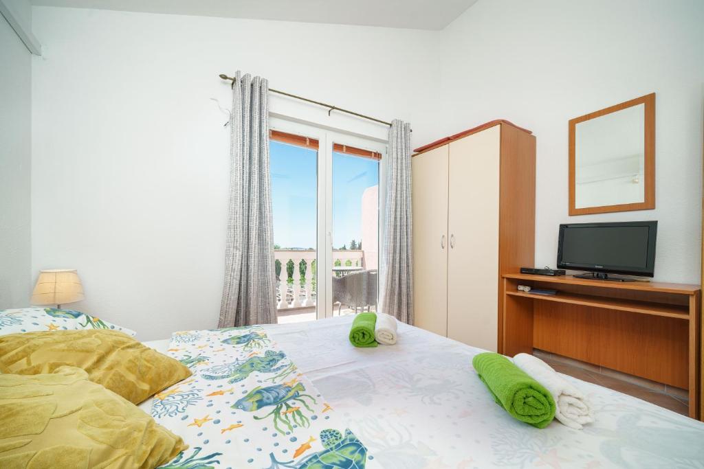 Postel nebo postele na pokoji v ubytování Apartments Markunović