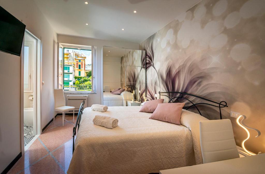 a bedroom with a bed with a painting on the wall at Il Maestrale in Santa Margherita Ligure