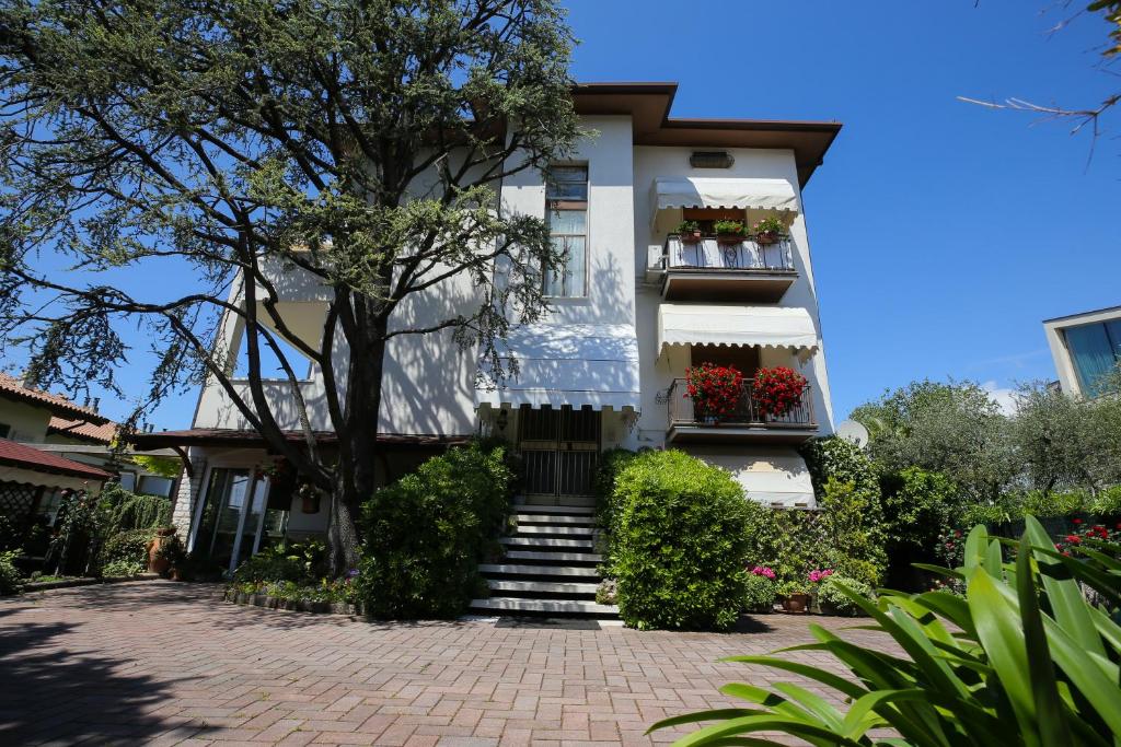 a white house with stairs and flower boxes at B&B Nonna Gina in Bardolino