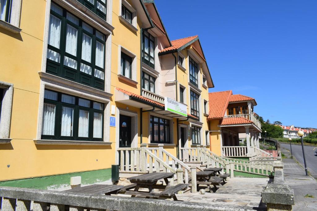 a building with a picnic table in front of it at Apartamentos VIDA Corcubión in Corcubión