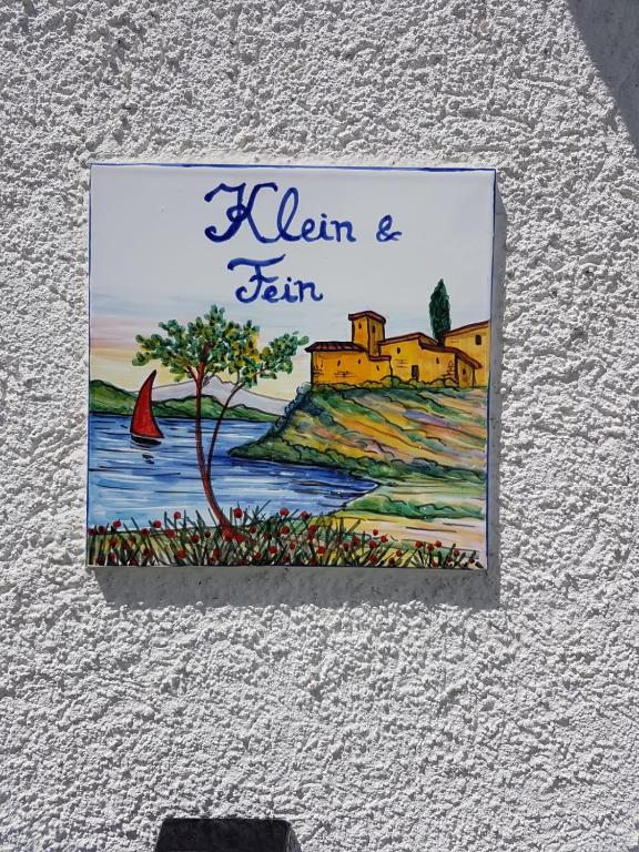 a picture of a sign hanging on a wall at "Klein & Fein" in Überlingen