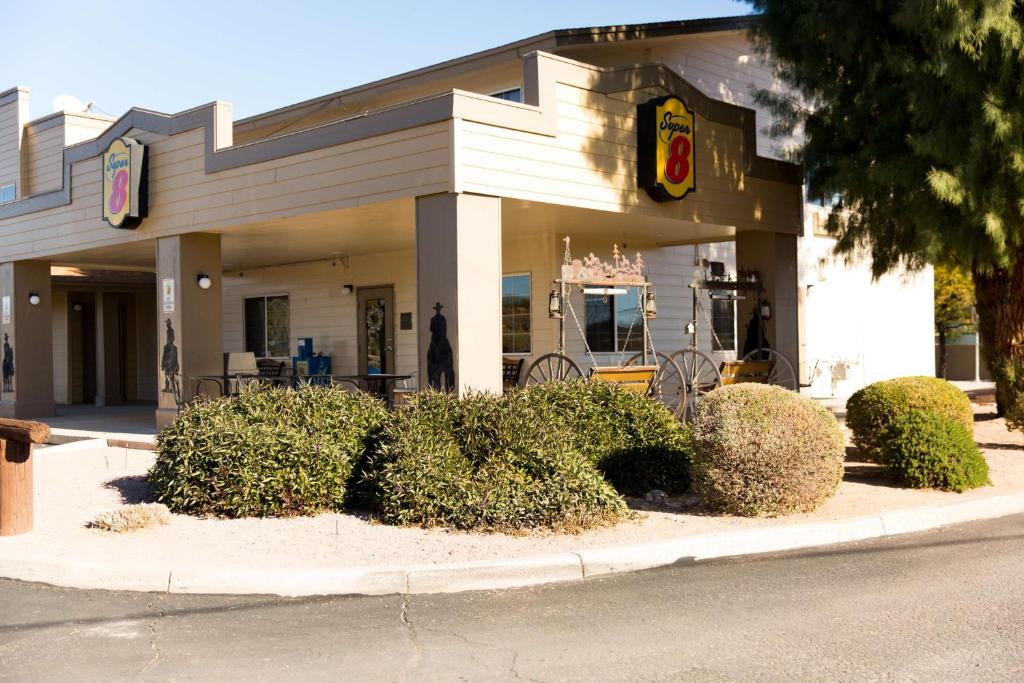 a fast food restaurant with bushes in front of it at Super 8 by Wyndham Wickenburg AZ in Wickenburg