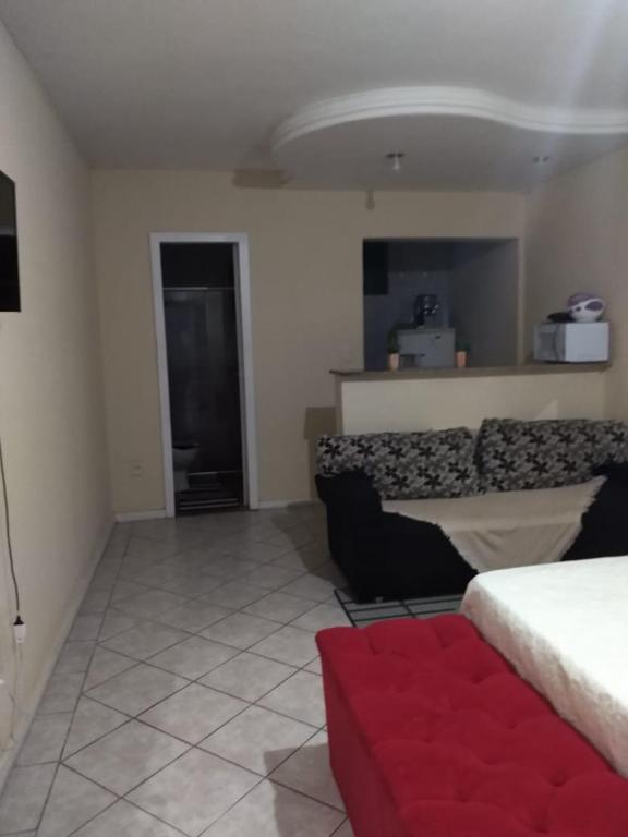 a living room with a bed and a couch at Apto no Centro in Campos dos Goytacazes