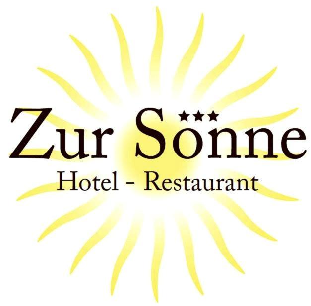a logo for a hotel restaurant with four stars at Hotel Sonne in Neuburg