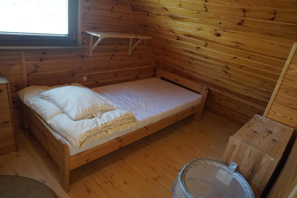 Postel nebo postele na pokoji v ubytování Osada Sosnowa