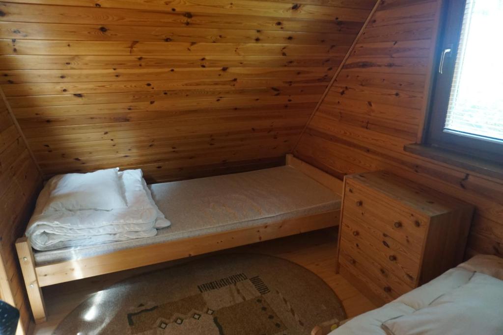 Postel nebo postele na pokoji v ubytování Osada Sosnowa