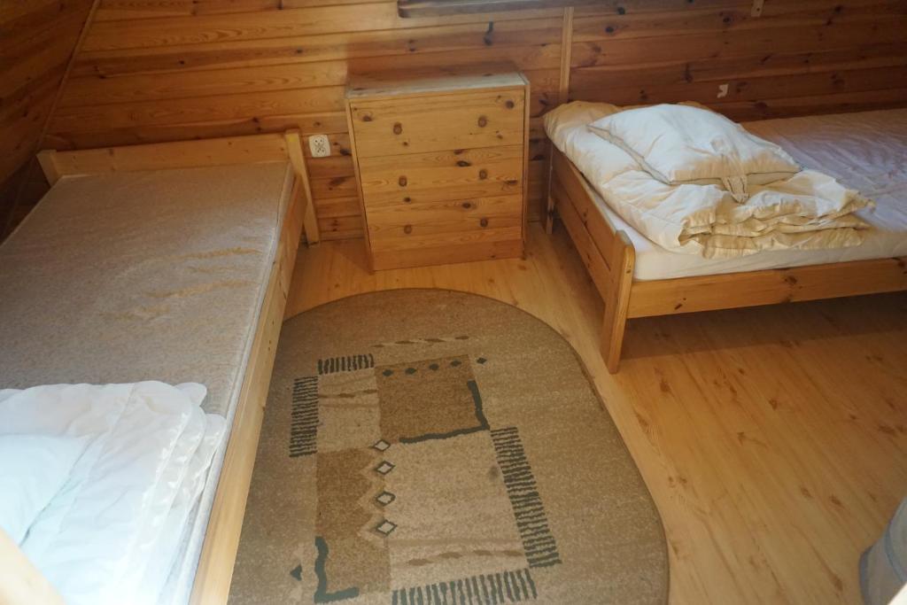 Postel nebo postele na pokoji v ubytování Osada Sosnowa