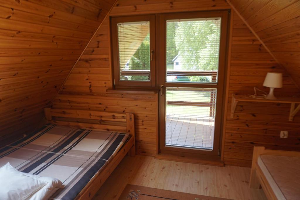 Postel nebo postele na pokoji v ubytování Osada Sosnowa