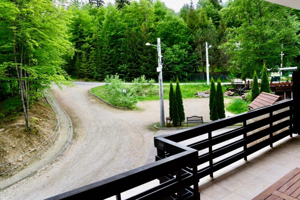 a view of a park from a balcony at Apartament Stanca Piticului in Sinaia