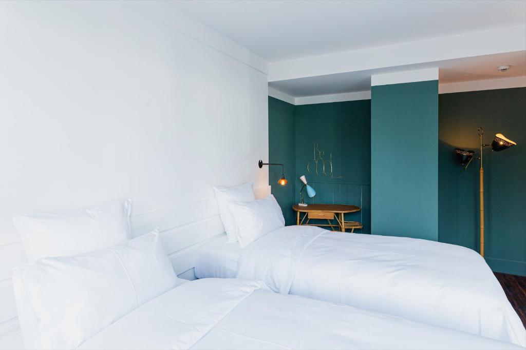 Postel nebo postele na pokoji v ubytování Bateau Libre Hotel