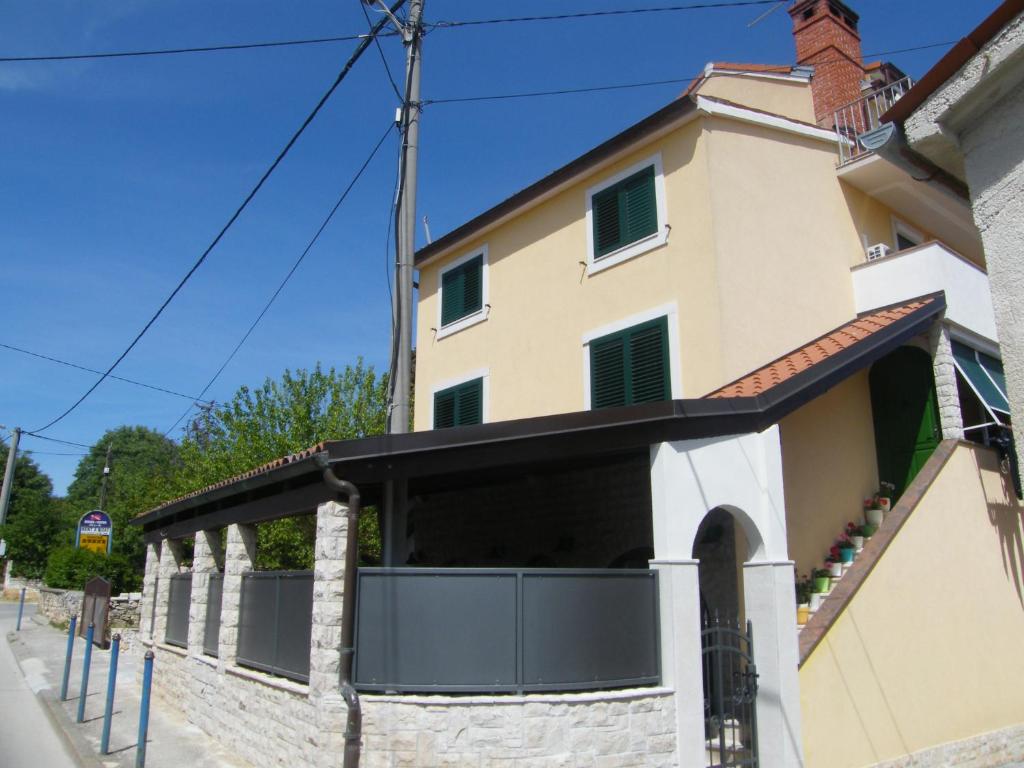 an external view of a building with a gate at Apartment Mamut in Premantura