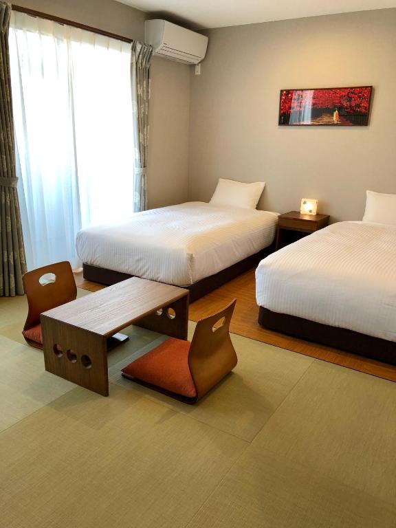 Postel nebo postele na pokoji v ubytování Yukari Kyoto
