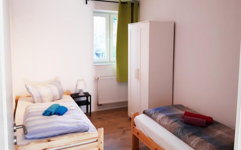 a bedroom with two beds with blue shoes on them at Workers House in zentraler, ruhiger Umgebung in Wernau
