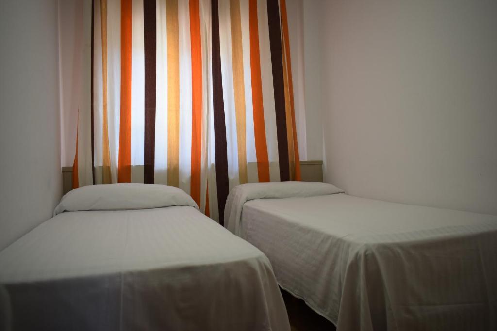 Posteľ alebo postele v izbe v ubytovaní Apartamentos VIDA Finisterre