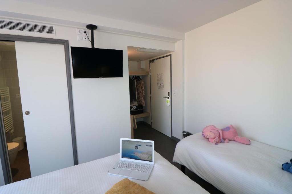 Postel nebo postele na pokoji v ubytování Hotel Le Virevent