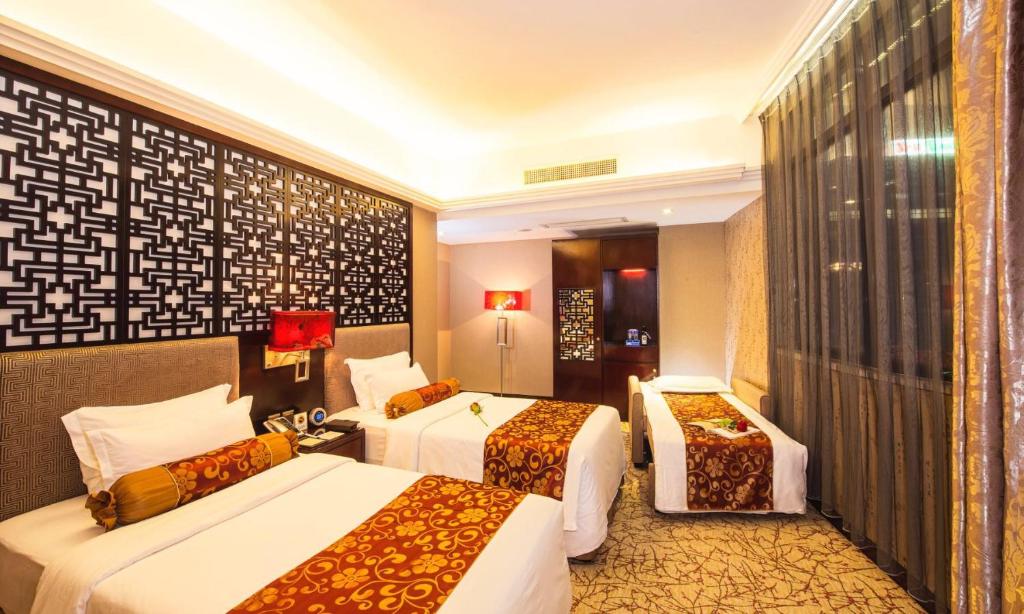 Postel nebo postele na pokoji v ubytování Hotel Metropole