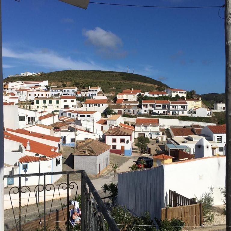 a town with white houses and a hill in the background at Carrapateira Lodge in Carrapateira