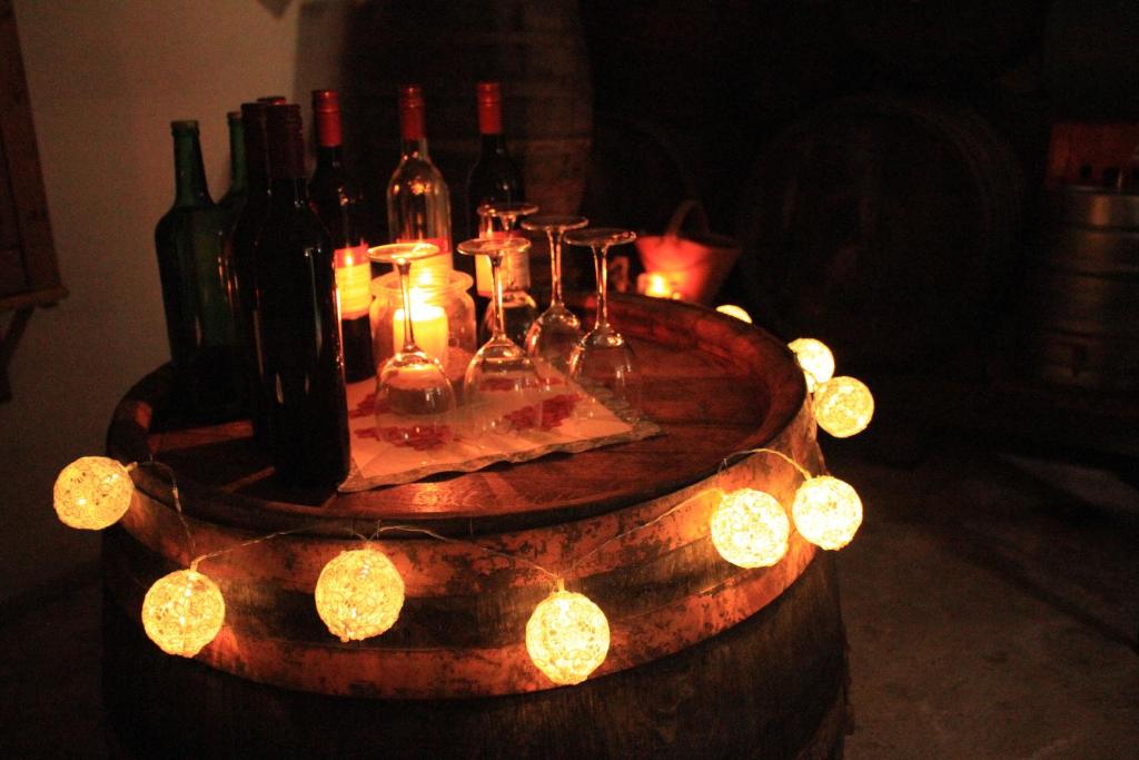 a barrel with wine bottles and lights on it at Buchschneider - Ferienhaus Maier - Landhof in Schwarzautal