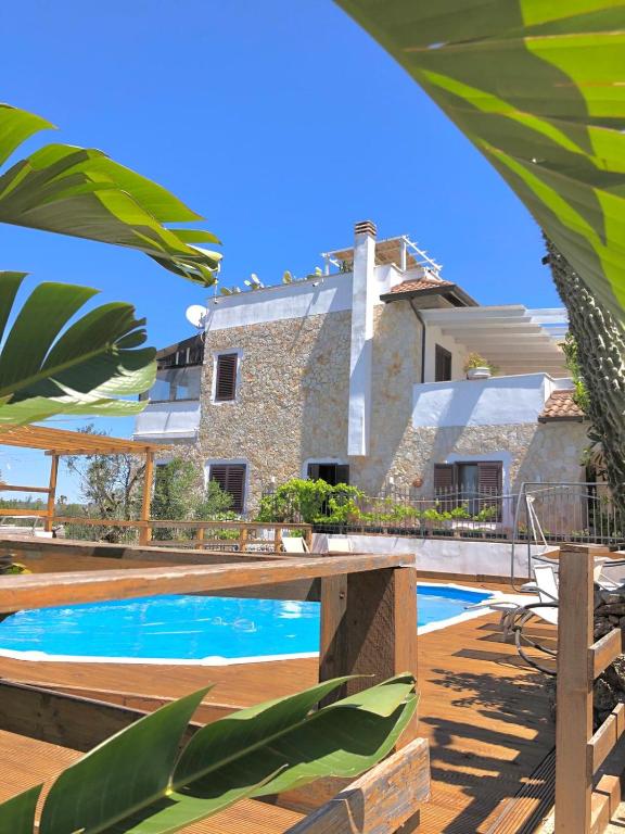 a villa with a swimming pool in front of a house at Villa Casa Vacanze Fiore in Gallipoli