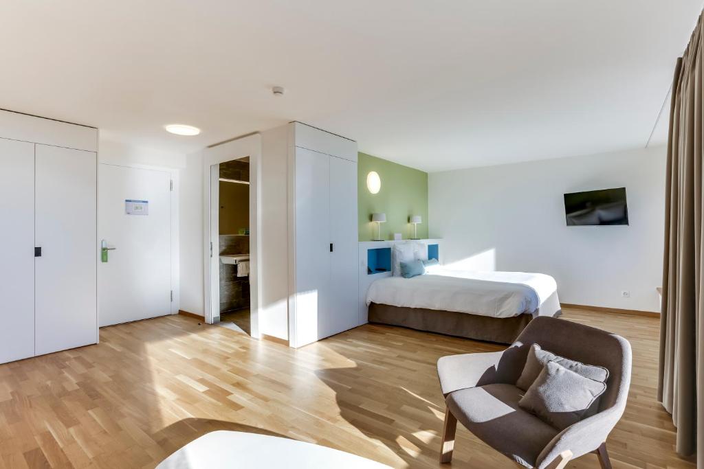 Postel nebo postele na pokoji v ubytování Hôtel des Patients