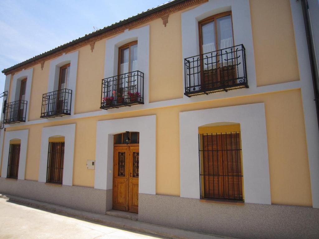 a building with three doors and two balcony at La Cantina de Daniel in Chatún