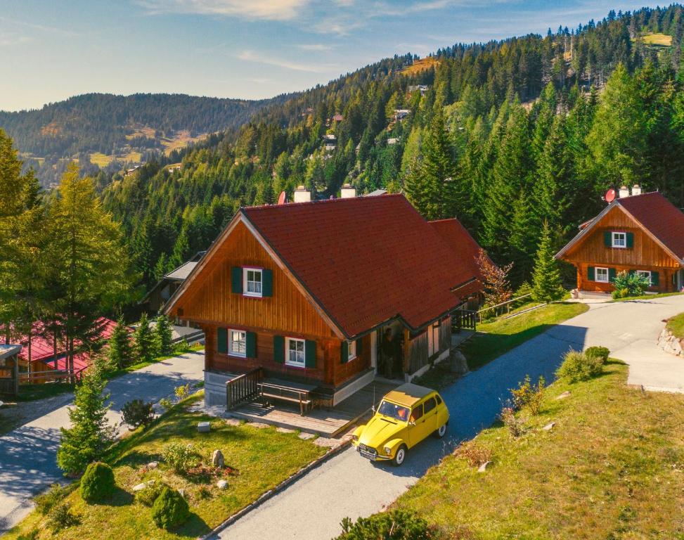 a yellow car parked in front of a house at Alpine Cabin in Klippitztorl