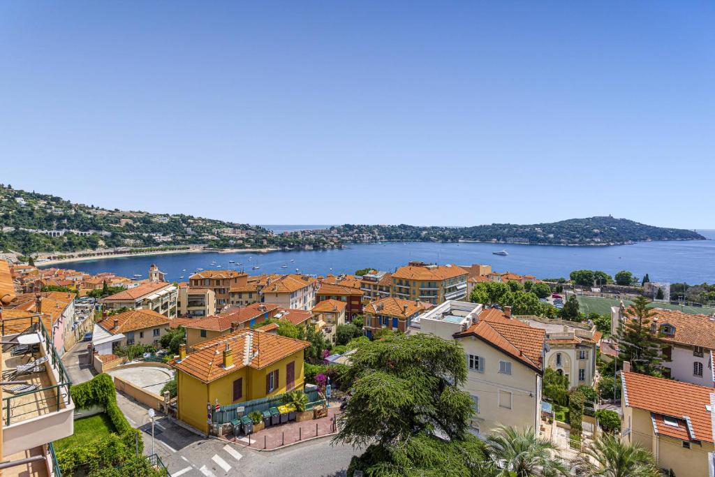 an aerial view of a town with a body of water at MY CASA - VILLEFRANCHE CAUVIN - Panoramic Sea View AC in Villefranche-sur-Mer