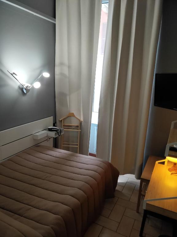 Postel nebo postele na pokoji v ubytování Hotel La Vignetta
