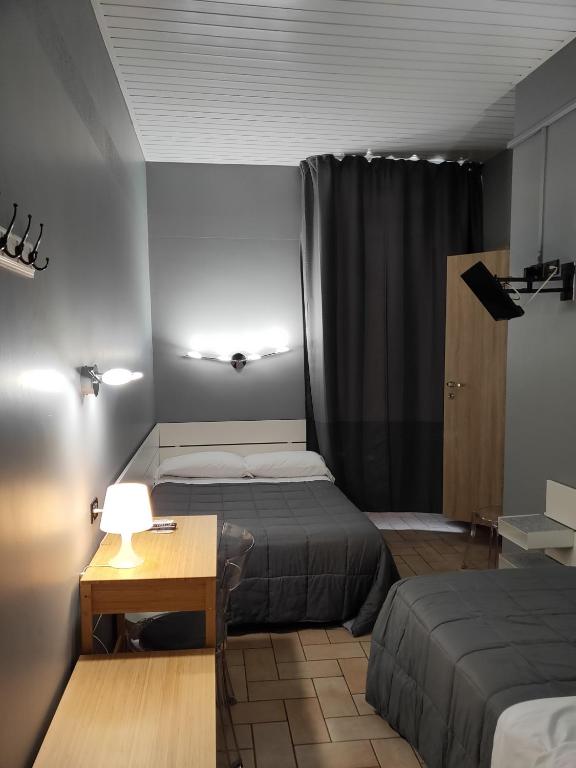 Postel nebo postele na pokoji v ubytování Hotel La Vignetta