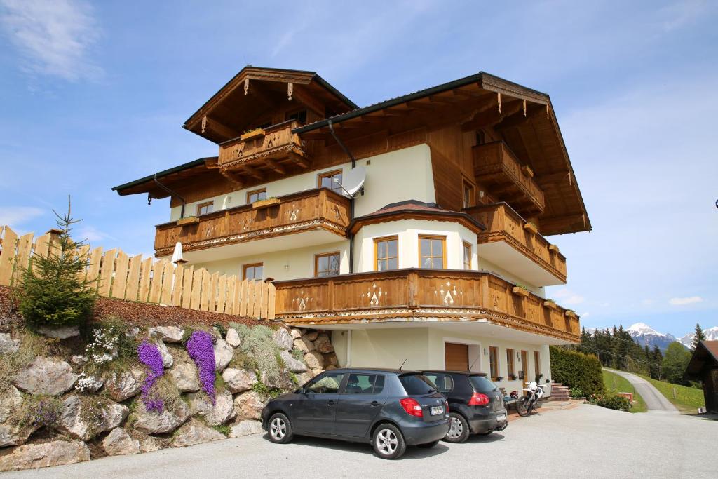 a large building with cars parked in front of it at Haus Obermoser in Flachau