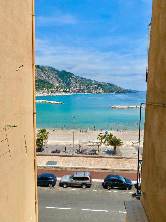 a view of a beach from a window of a building at Les Sablettes in Menton