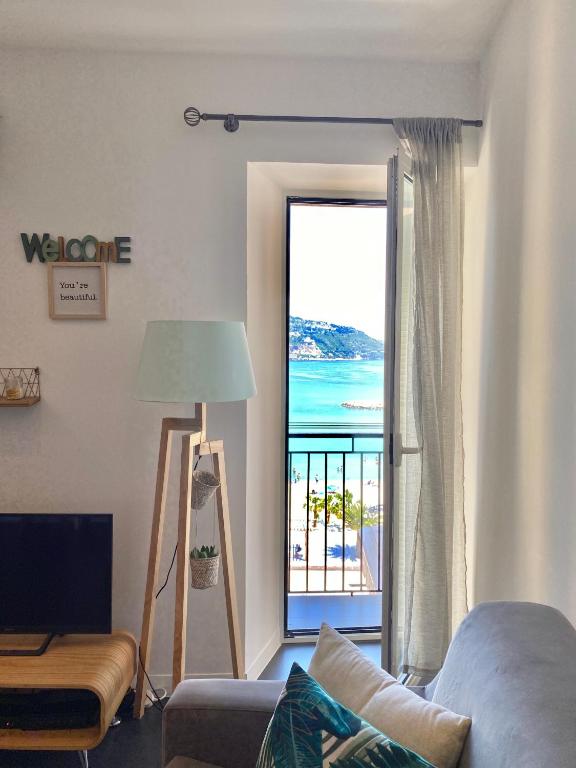 a living room with a view of the ocean at Les Sablettes in Menton