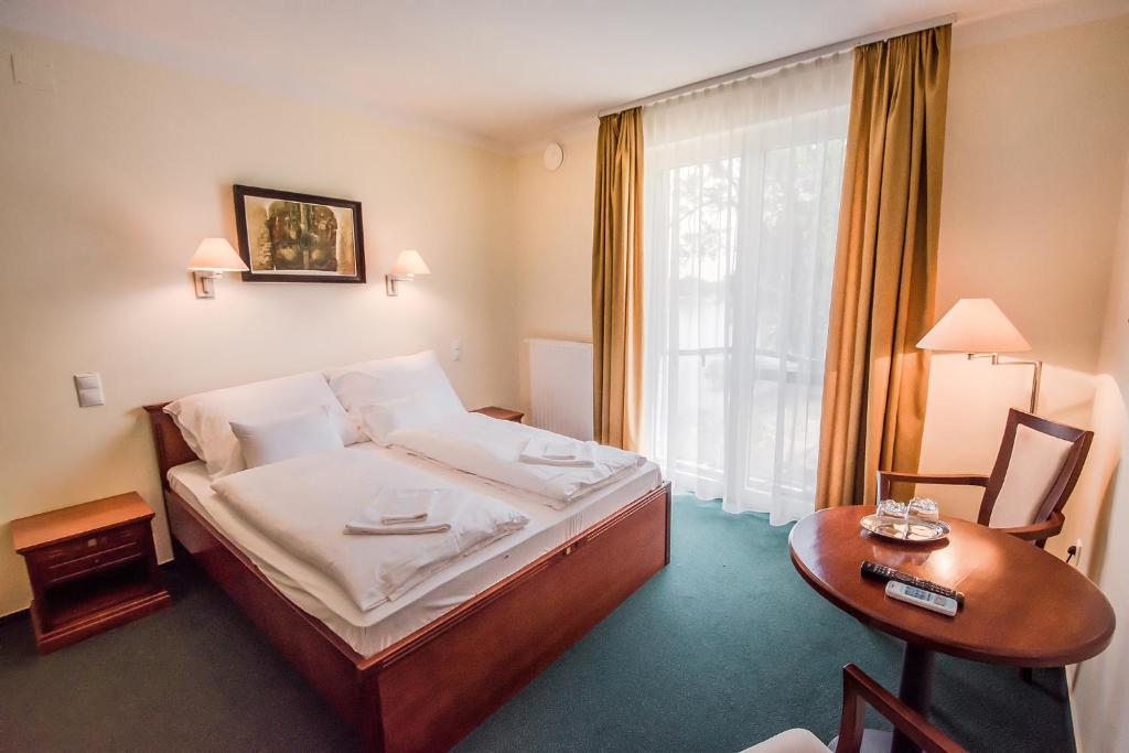 Postel nebo postele na pokoji v ubytování SZIGET HOTEL VERÁNKA