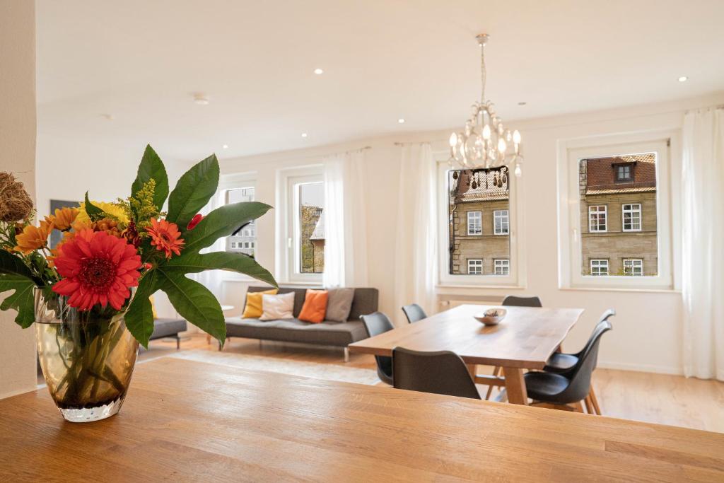 a living room with a vase of flowers on a table at Am Spittlerturm in Nuremberg