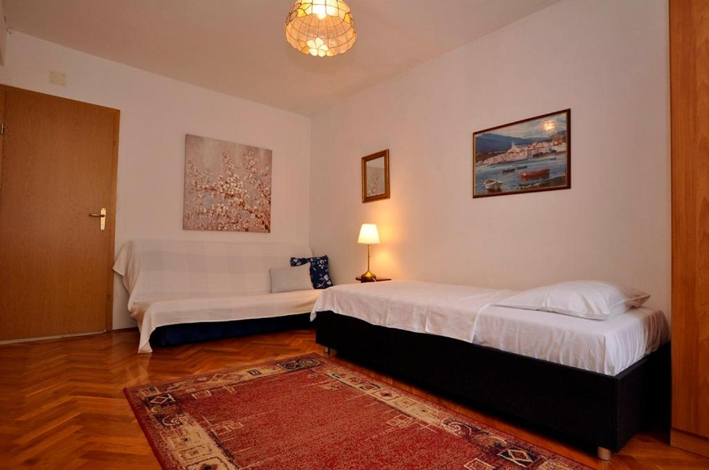 Postel nebo postele na pokoji v ubytování Apartmani More