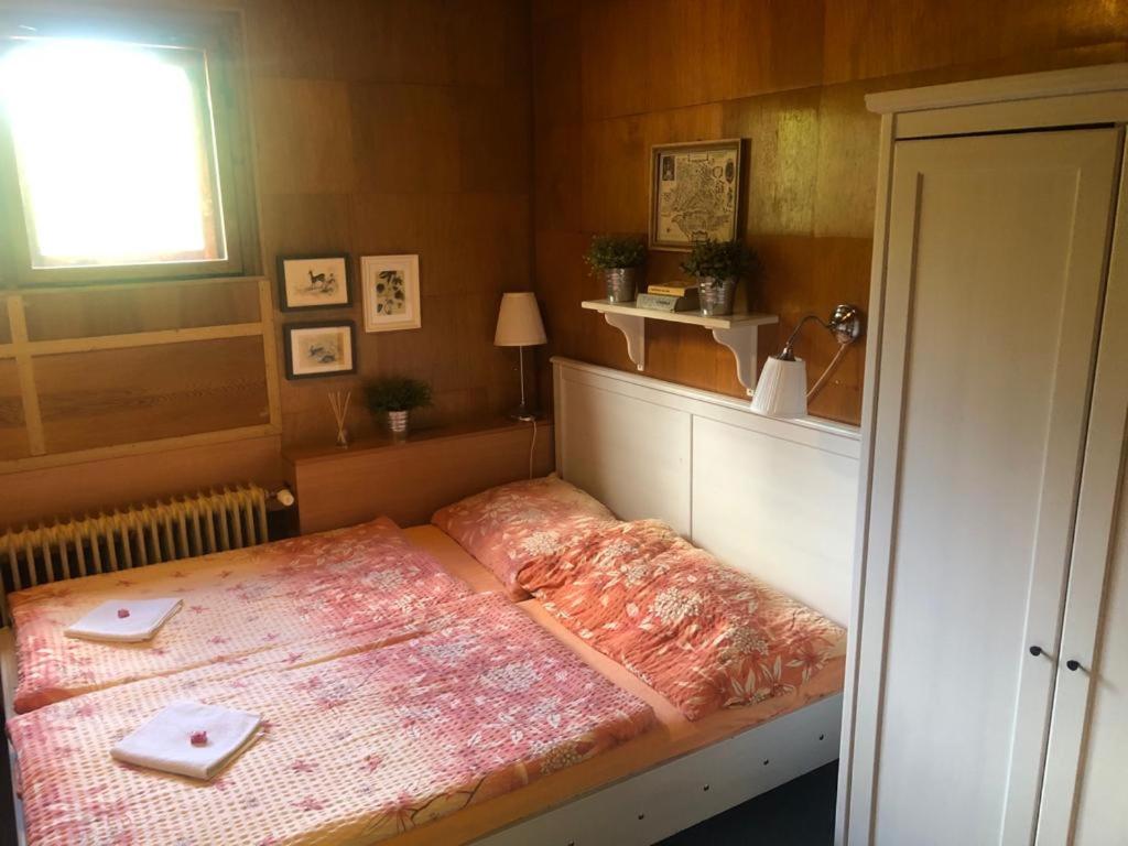 a small bedroom with a bed in a room at Turistická Chata Pláně in Český Dub