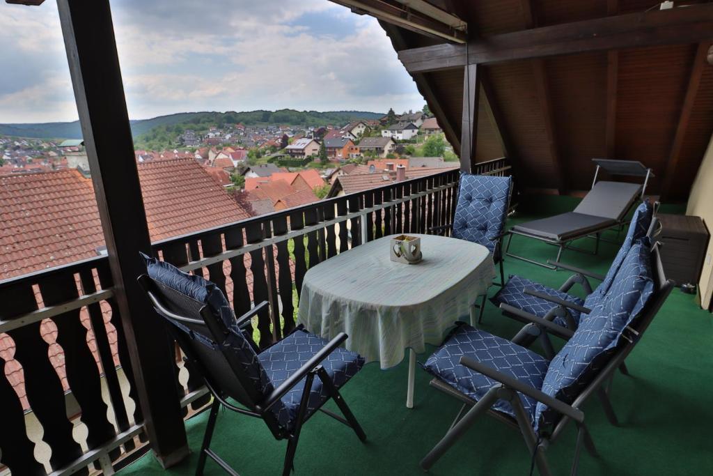 a table and chairs on a balcony with a view at Ferienwohnung Moemlingtal in Momlingen