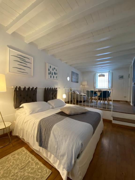 een slaapkamer met een groot bed en een tafel en stoelen bij La Casetta del Porto in Sulzano