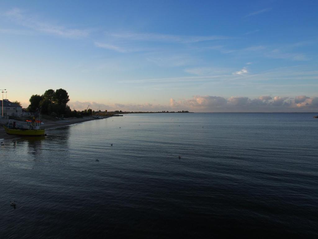 a large body of water with a boat in it at Grafit in Mechelinki