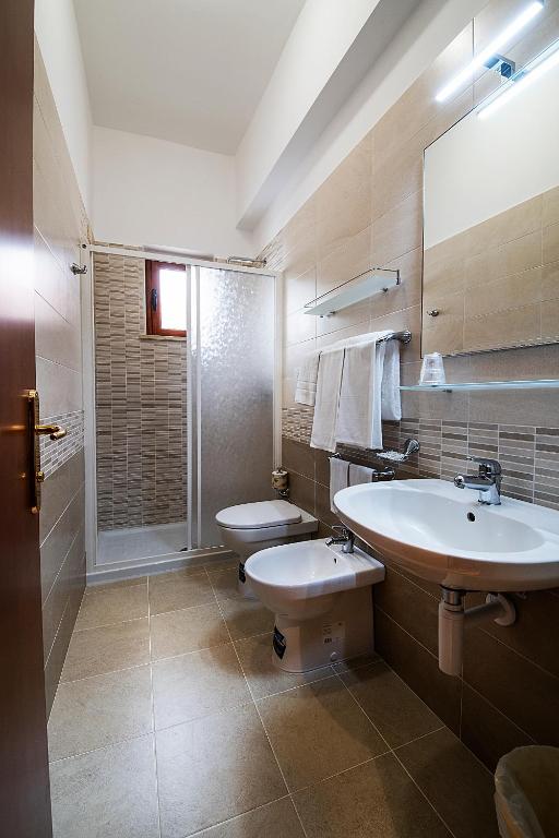 a bathroom with a sink and a toilet at Il Nocchiero City Hotel in Soverato Marina