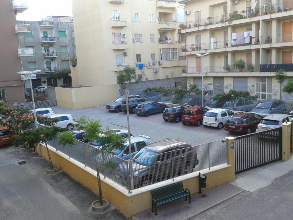 a parking lot with cars parked in front of a building at Il Nocchiero City Hotel in Soverato Marina